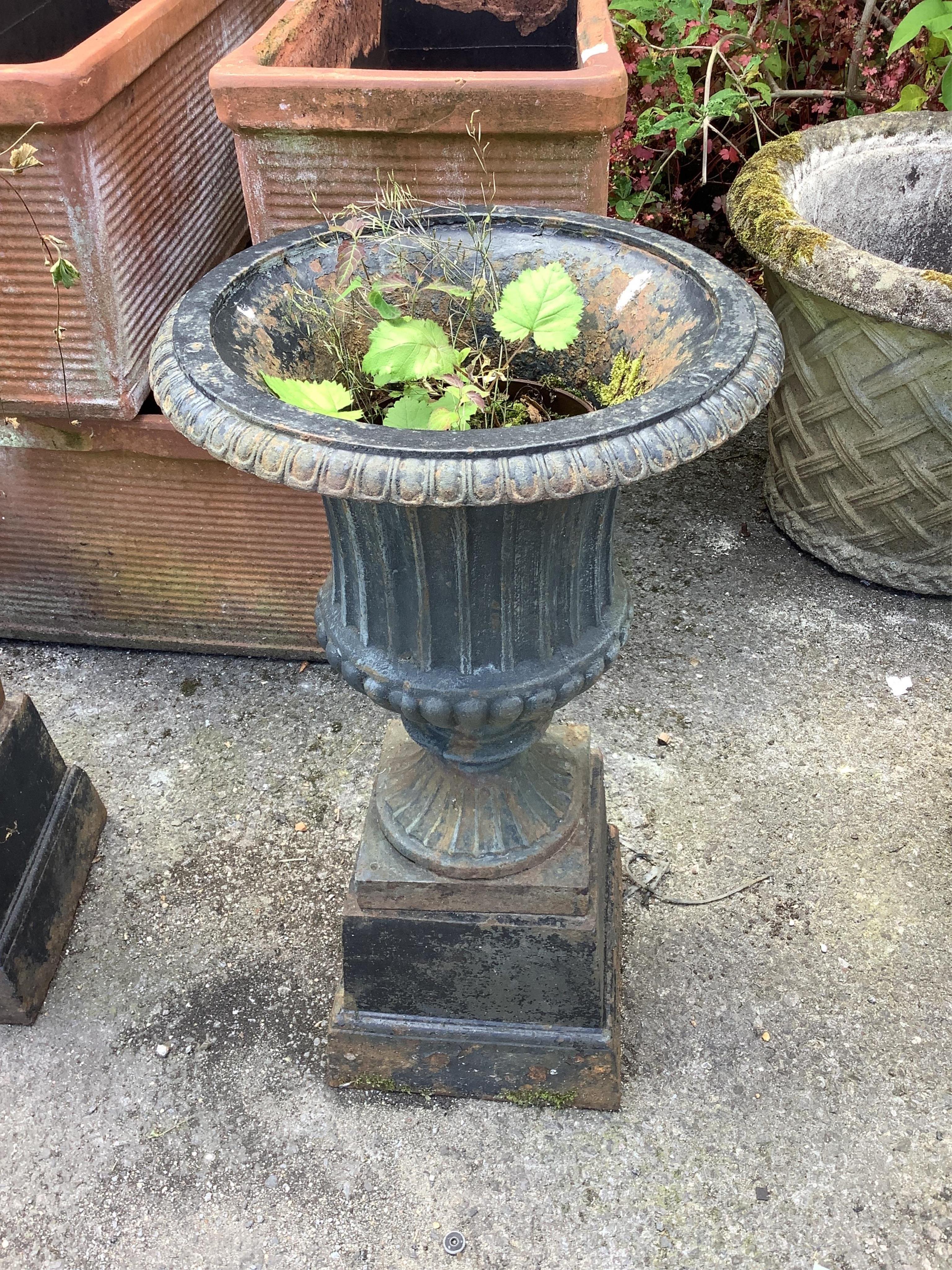 A pair of Victorian style circular black painted cast iron campana urns on stands, diameter 38cm, height 67cm. Condition - fair